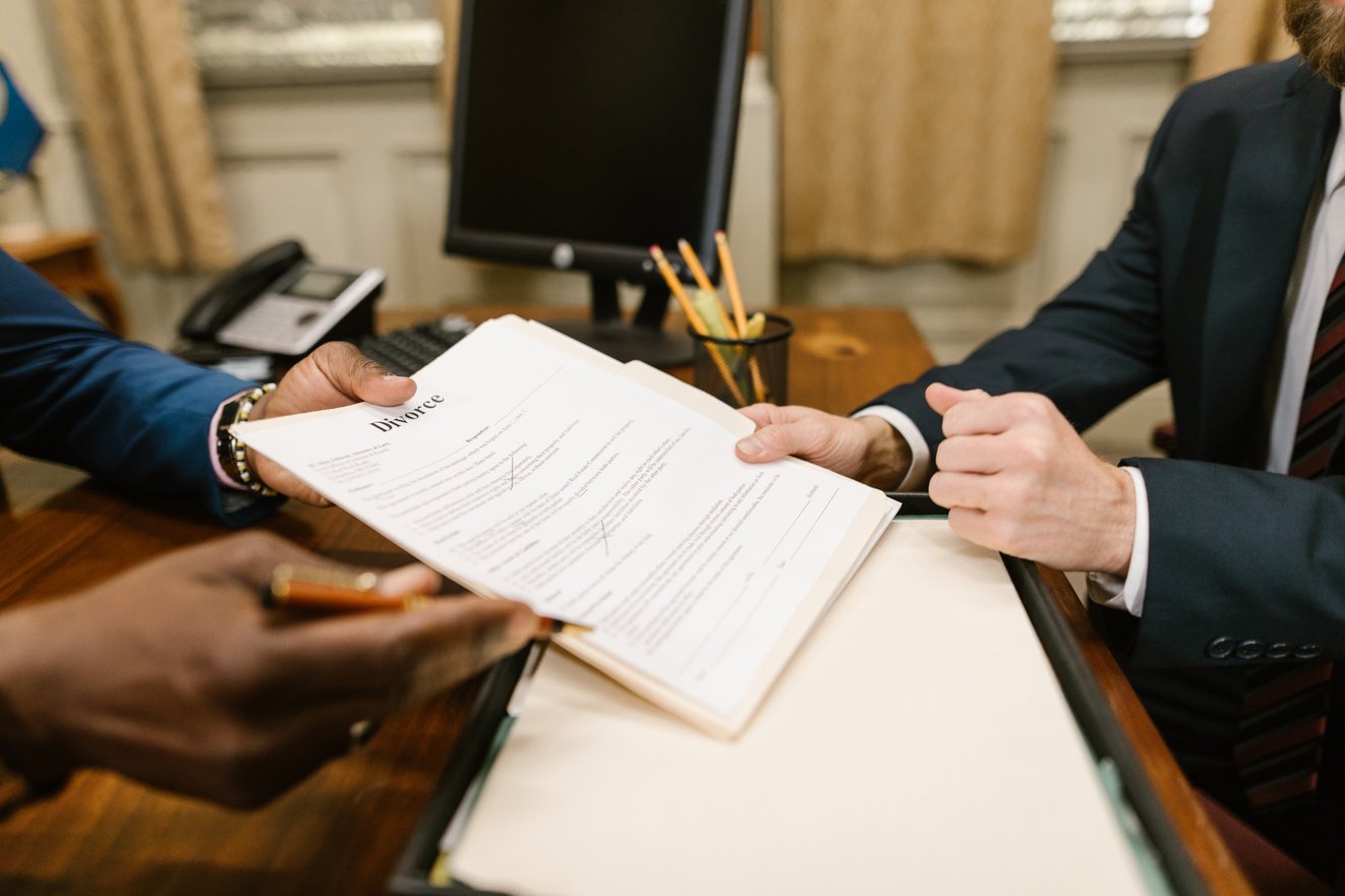 Close-Up Shot of a Person Holding Divorce Papers