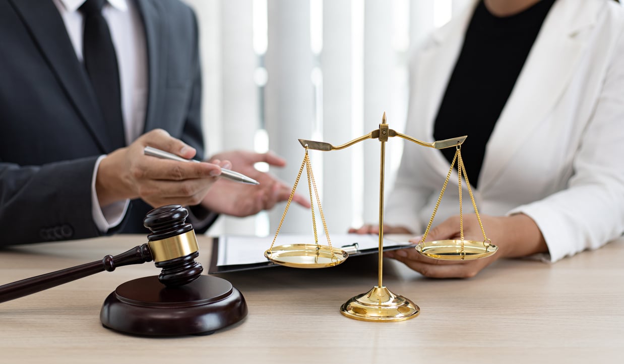 Lawyers with Judge Gavel and Justice Scales on Table 